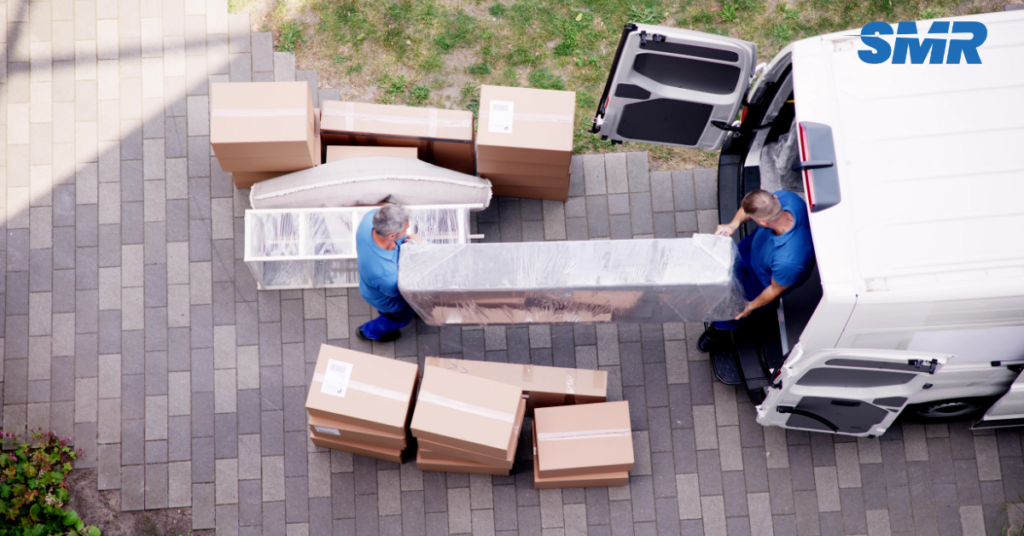 Professional man with a van unloading boxes in Collier Row for a home move.