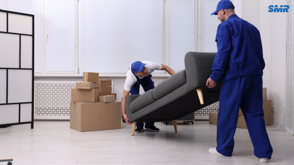 2 man and van Westminster carrying sofa into van professional movers teamwork