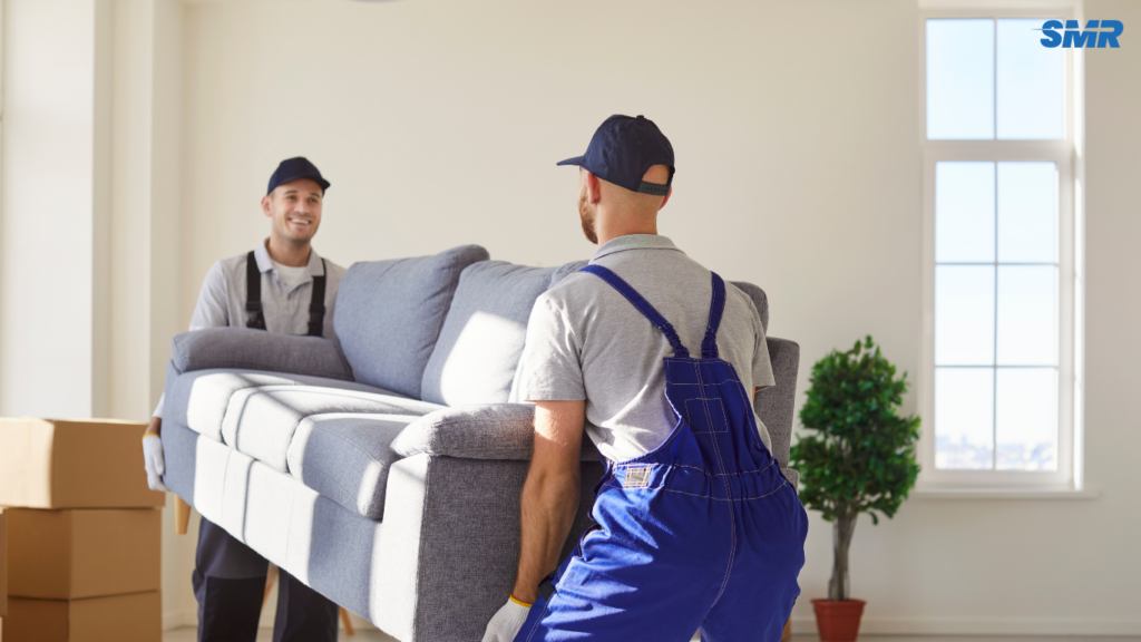 Two movers carrying a sofa in Whitechapel