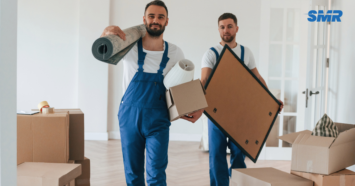 Man and Van Greenwich team loading furniture into a branded Sureman Removals van outside a home in Greenwich, London
