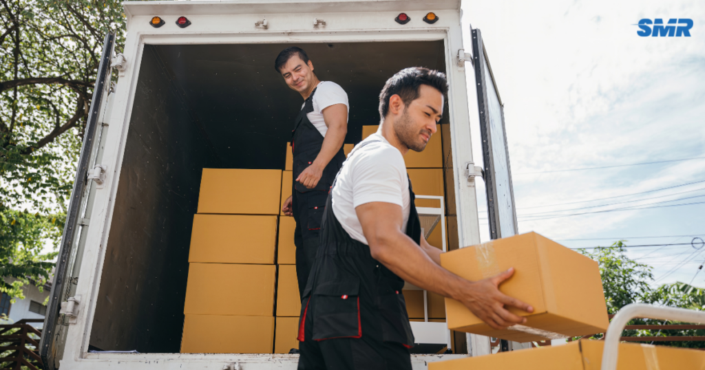 Man and Van Harrow mover loading boxes into a removals van