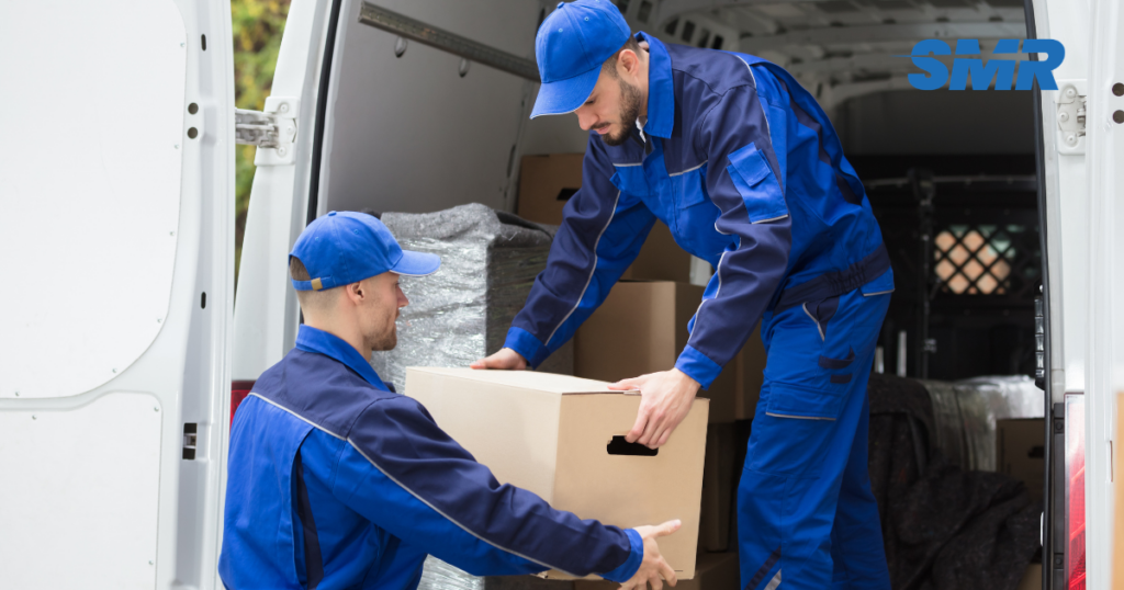 Man with a van Grays cheapest movers lifting sofa carefully inside a home
