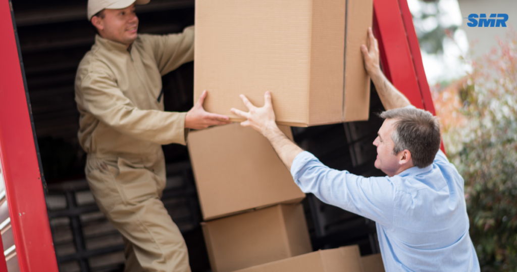 man with a van Greenford cheap movers lifting sofa carefully inside a home
