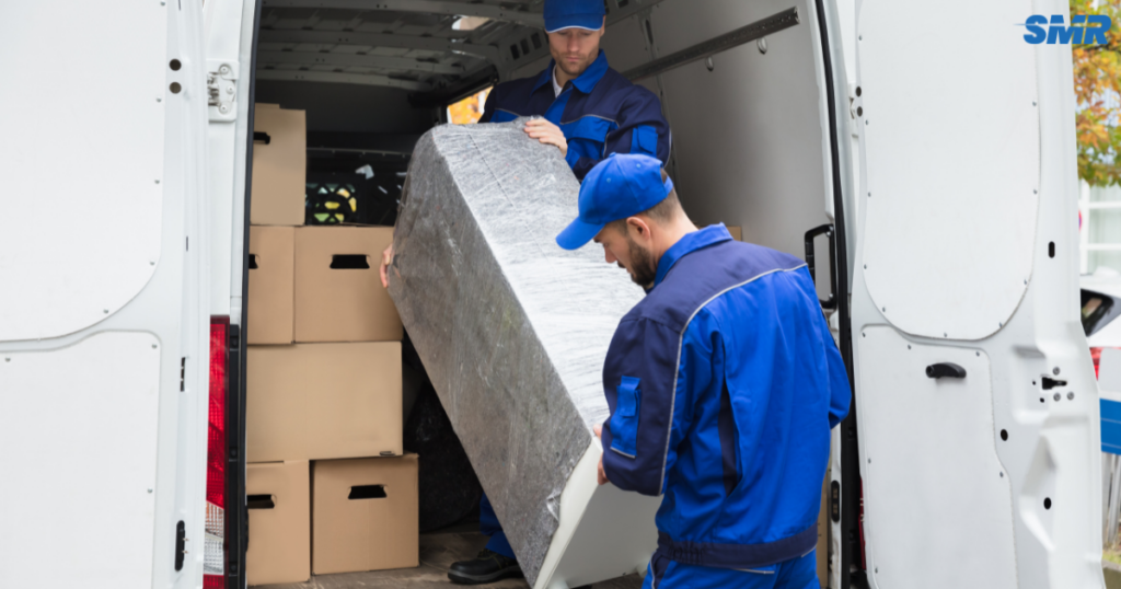 cheap man and van Bromley same day removals service with movers loading furniture into van