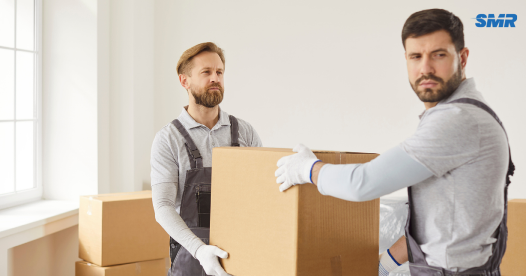man with a van Gunnebury cheapest movers lifting a sofa carefully inside a home