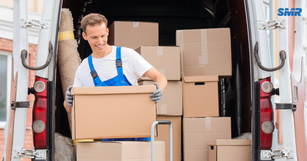 cheap man and van Greenwich loading boxes into van during house move