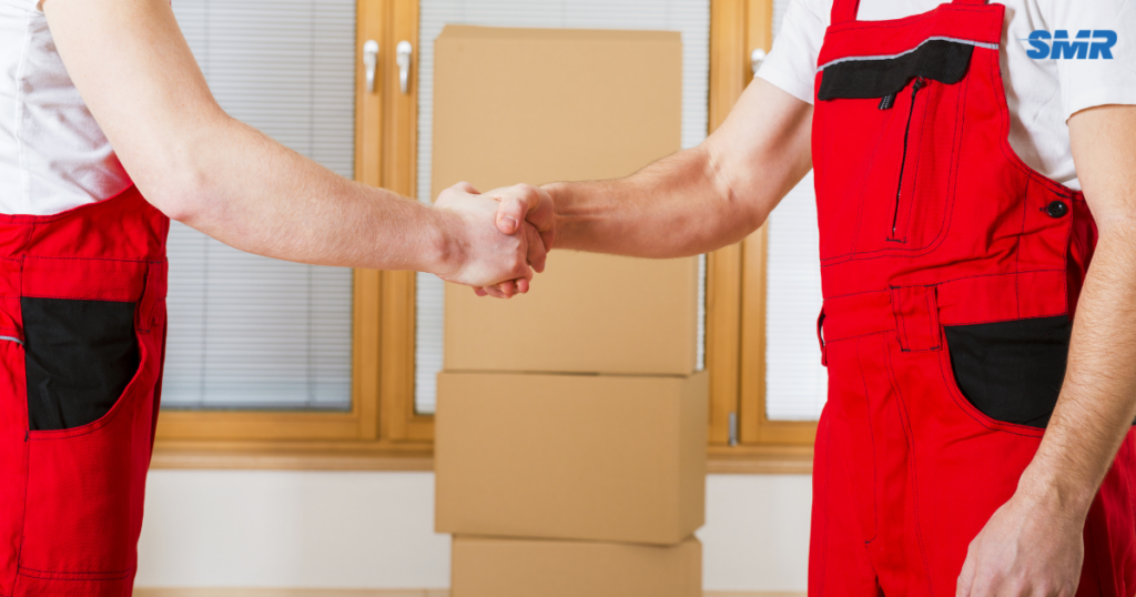 man with a van Hackney movers lifting sofa carefully inside house