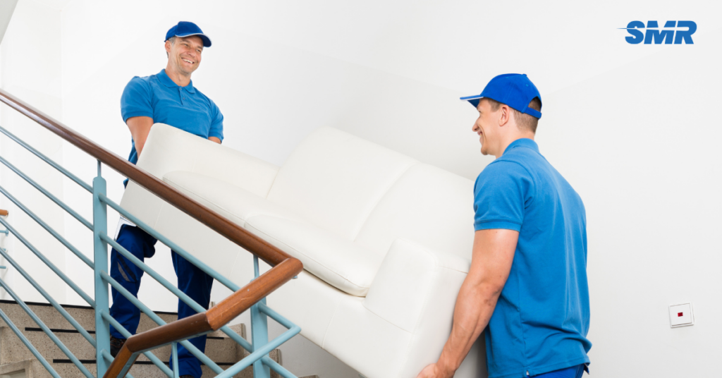 Two movers carrying sofa into van in Cockfosters EN4