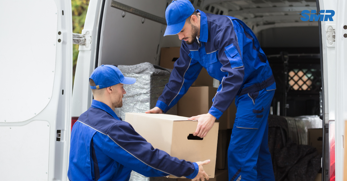 two movers arranging boxes on trolley in Hackney