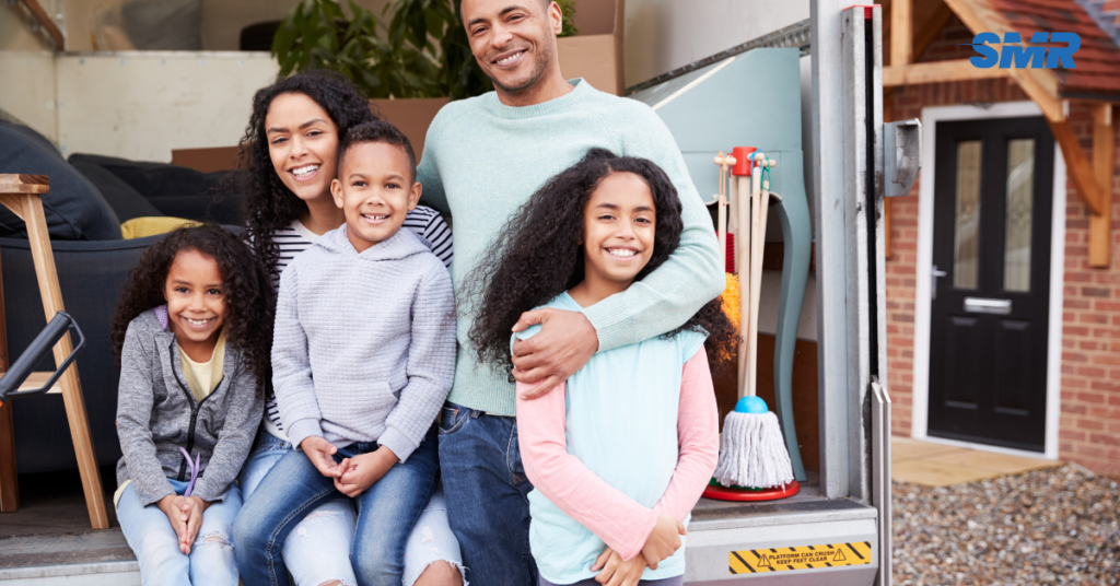 Happy family moving furniture with Sureman Removals' man and van service in Barkingside, providing smooth and affordable moves.