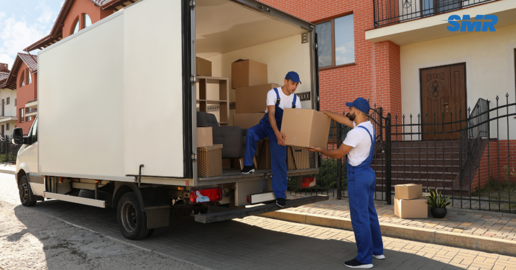 two movers carrying an item into van man and van Brixton service teamwork