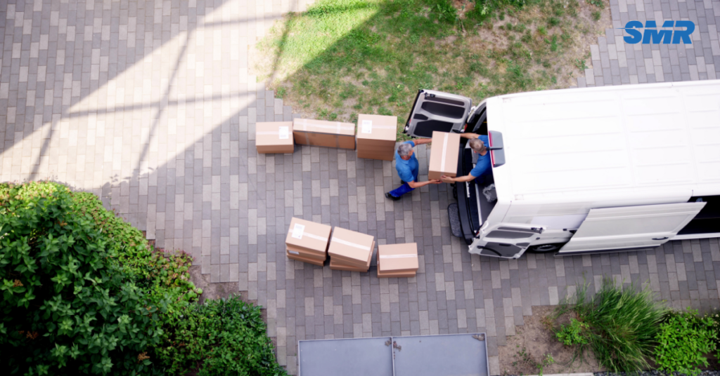 two movers loading an item into van in Collier Row RM5