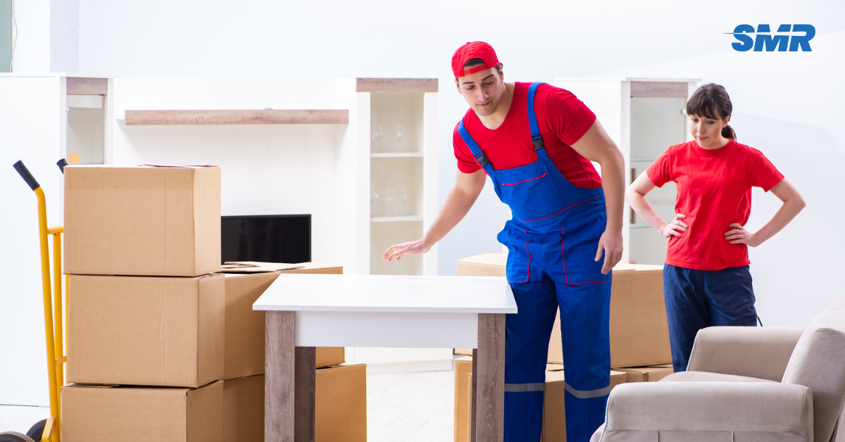 Flat removals Parsons Green movers carrying sofa into apartment building