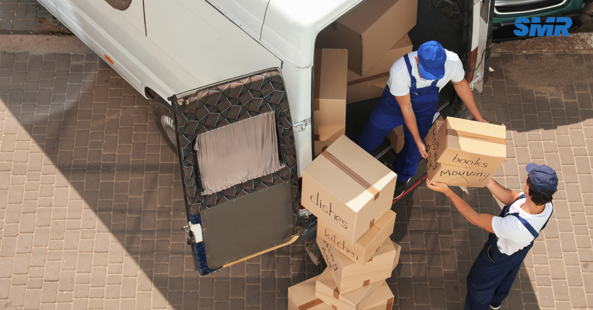 house removals Newham movers carrying sofa into van