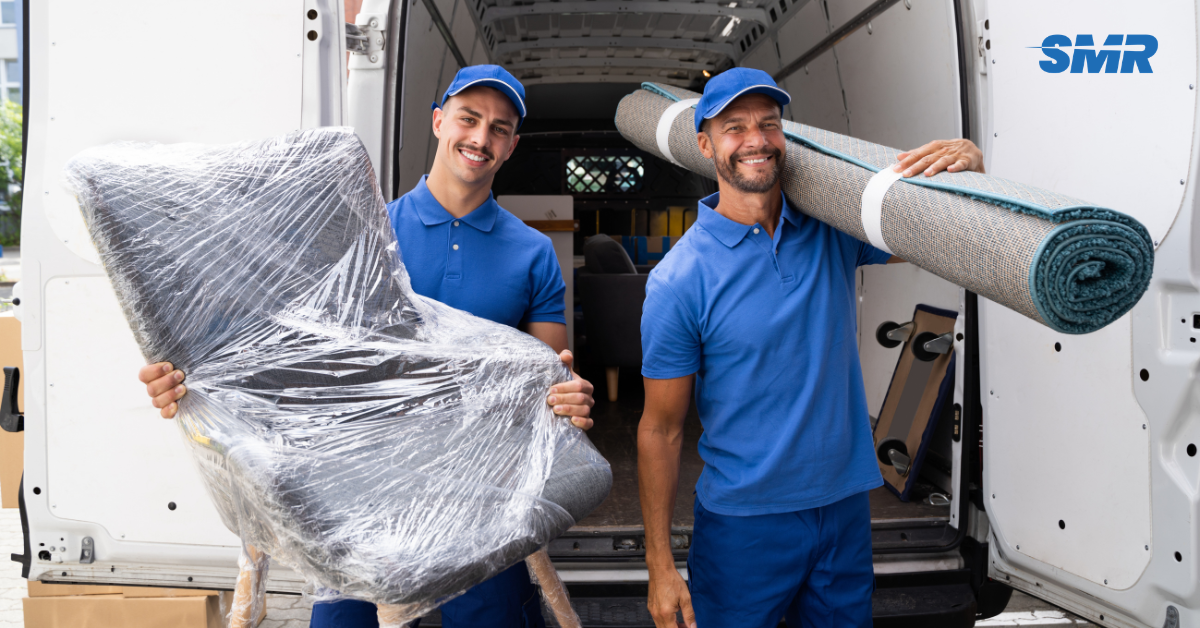 Flat removals Plaistow movers carrying sofa into apartment building