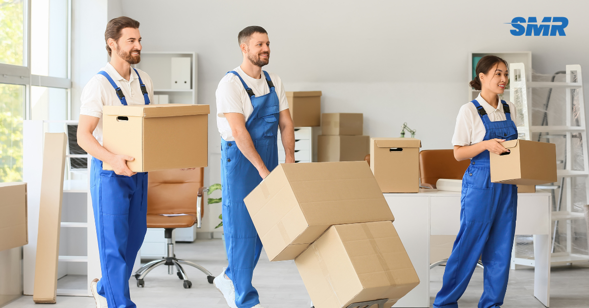 Mover loading boxes into a Sureman Removals van in North Finchley
