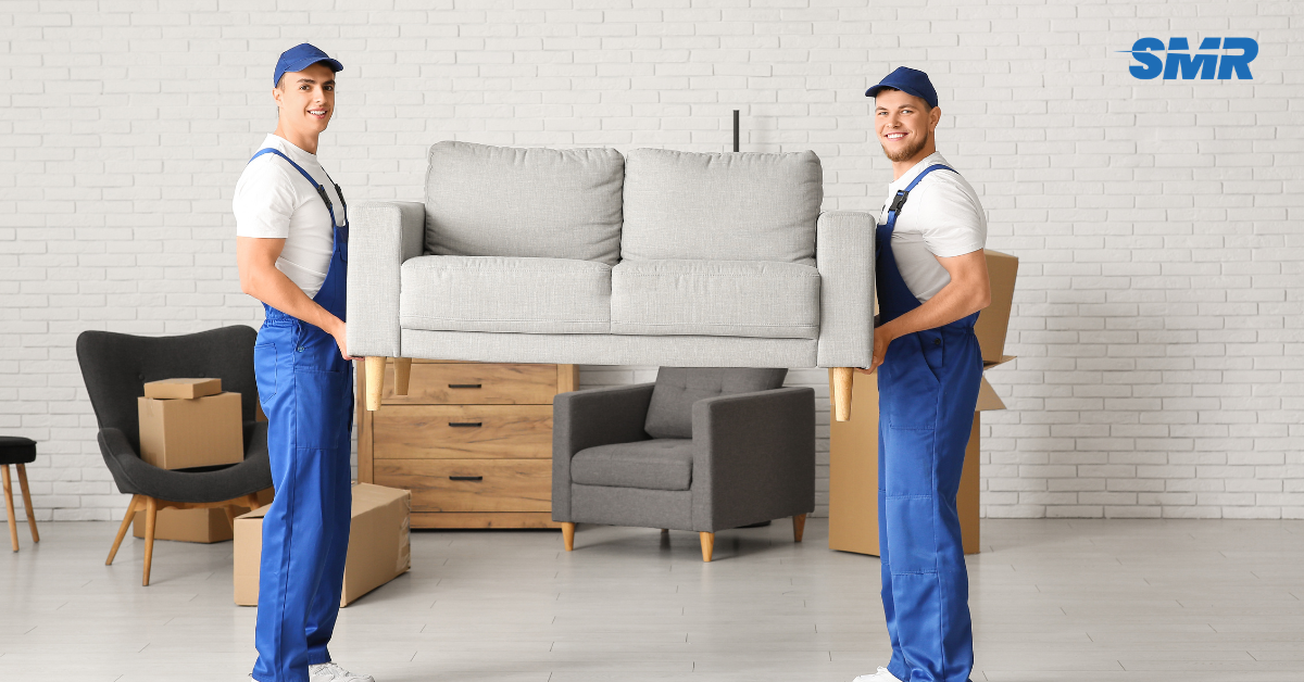 Flat removals Orpington movers carrying sofa into apartment building