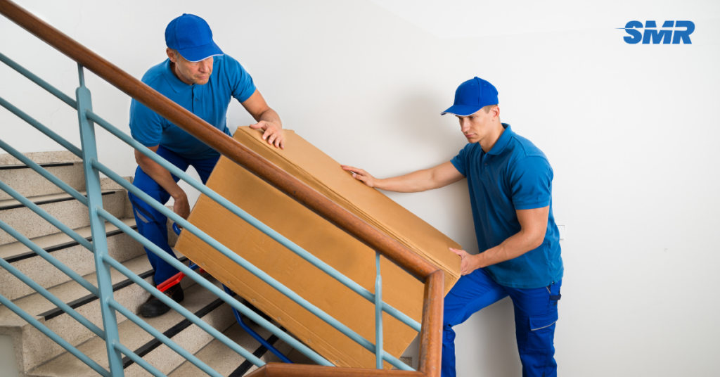 house removals Kensal Green movers carrying sofa into home happy customer