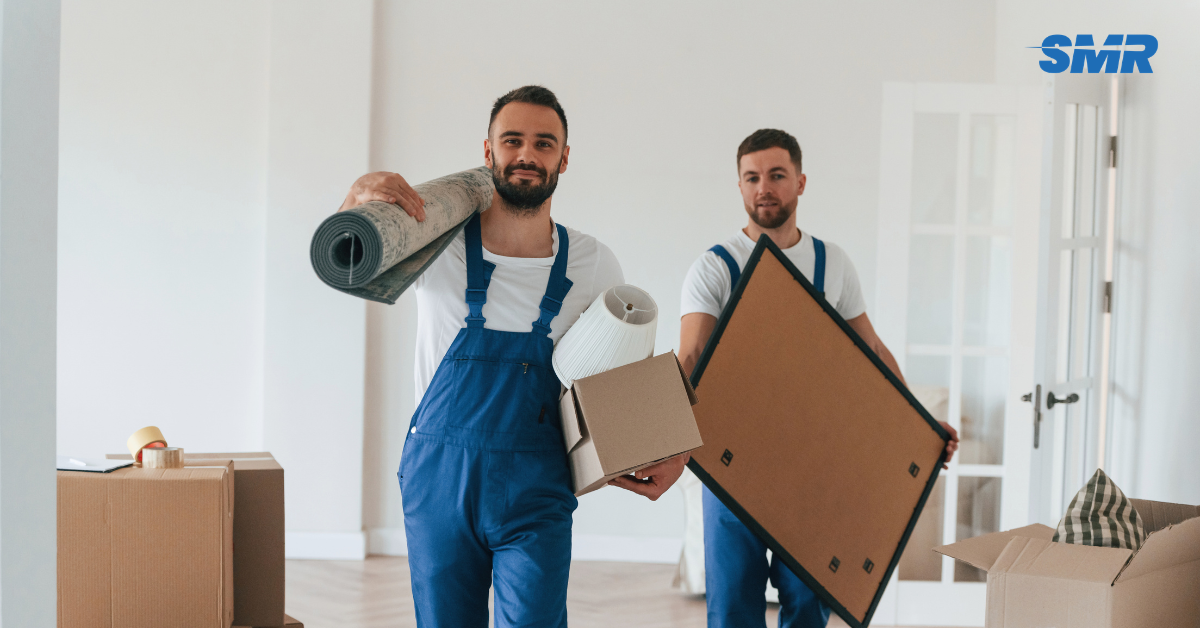 Flat removals Notting Hill movers carrying sofa into apartment building