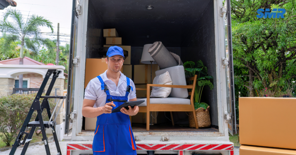 Professional man and van Kentish team loading furniture into a removals van during a home move in Kentish, NW1.