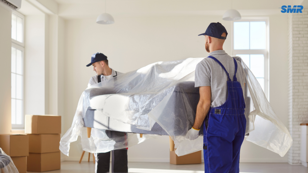 Two movers carrying sofa for 2 man and van Acton service