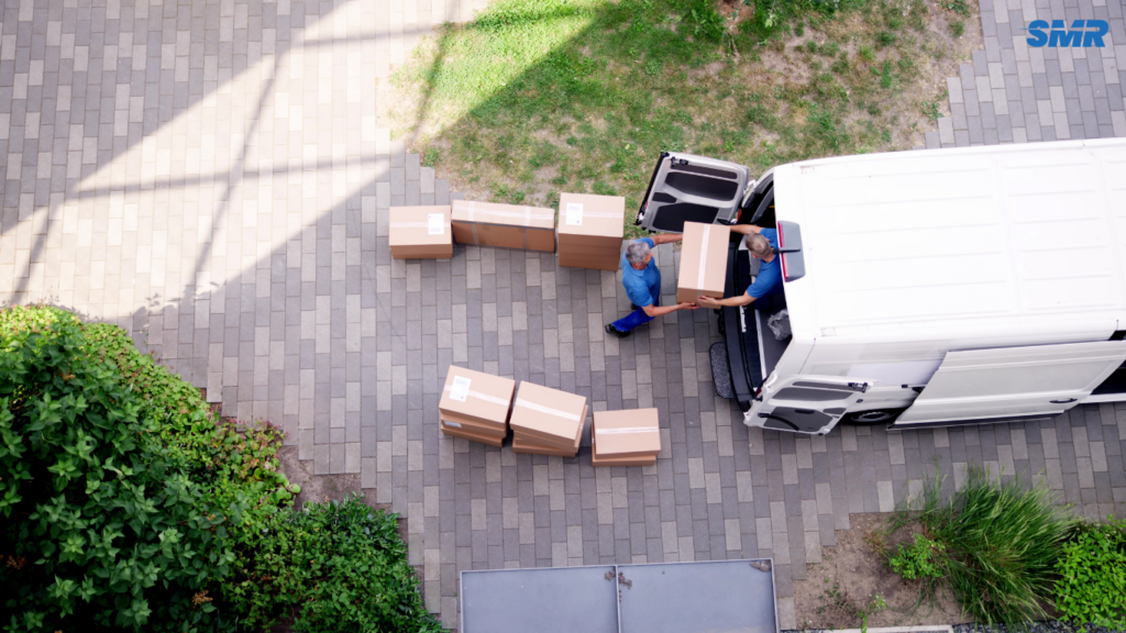 Man and van team loading household furniture into a removal van in Willesden