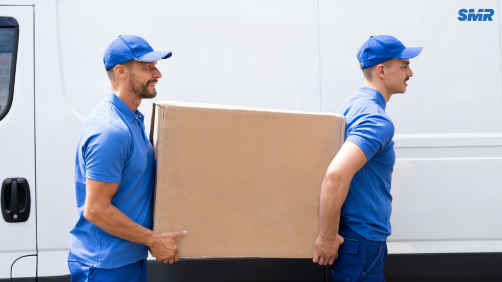 Mover loading furniture boxes for delivery in Acton