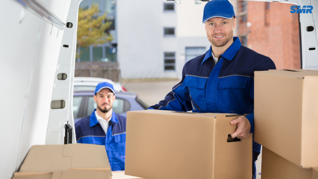 Man and van team in Woolwich loading furniture and boxes into a removal van