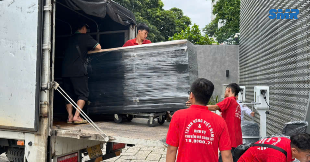 Man and van Cockfosters team loading furniture into van for house move in London