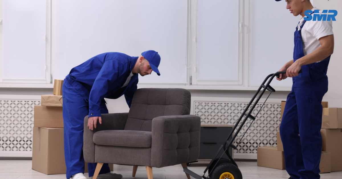 Experienced movers carrying a sofa into a home in Kensal Green