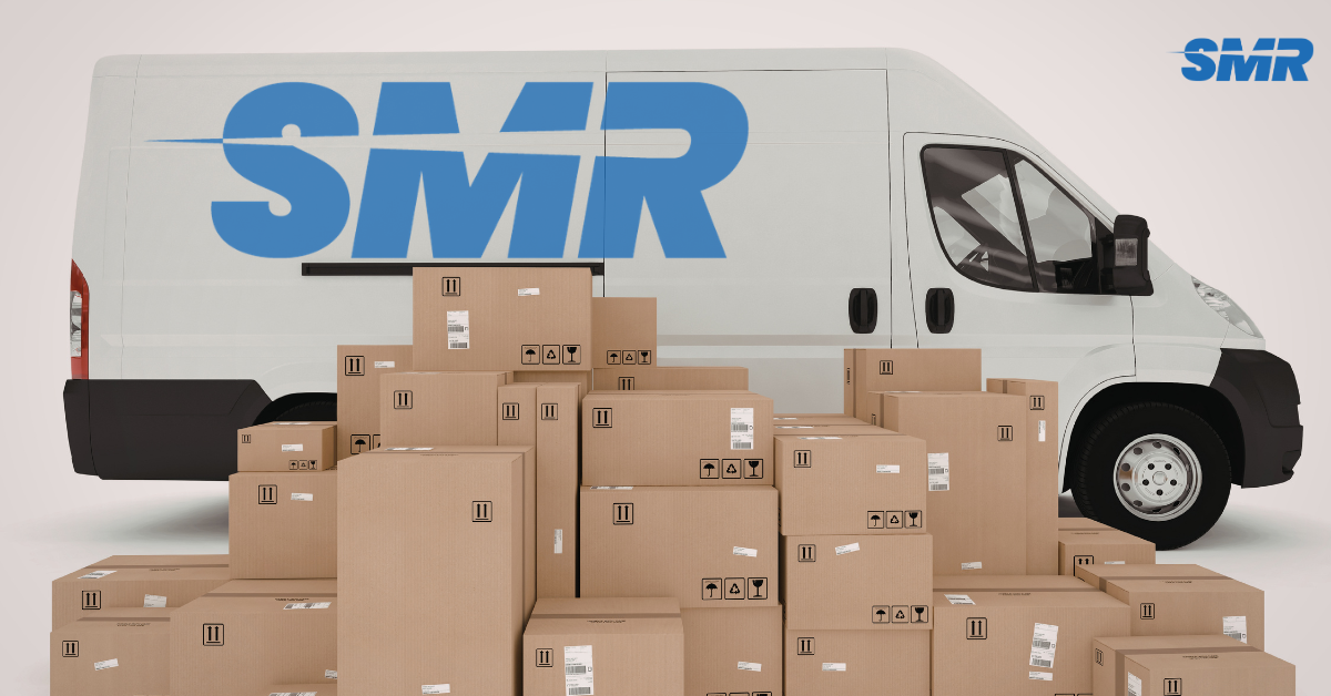 Sureman Removals van in Kensal Green with moving boxes nearby.