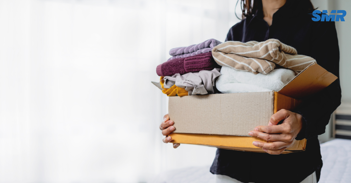 Two movers carrying a sofa into a house during a Kentish move.
