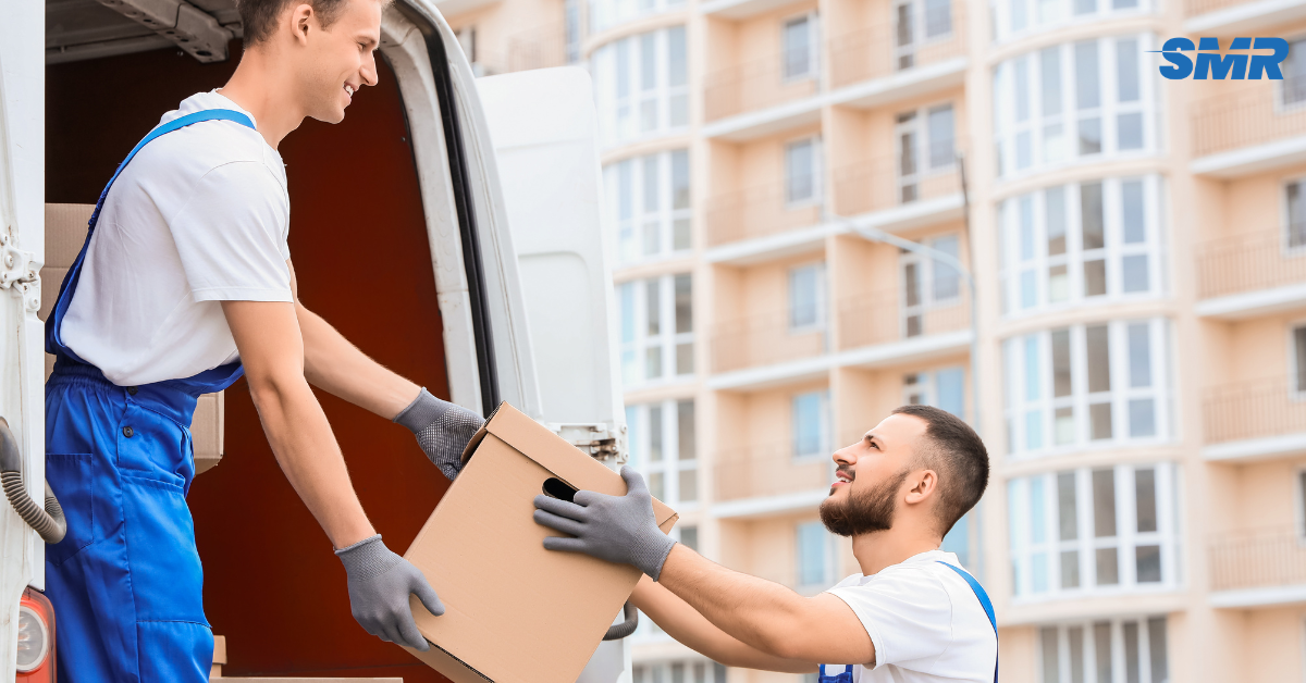 house removals Hornchurch movers carrying sofa into home happy customer