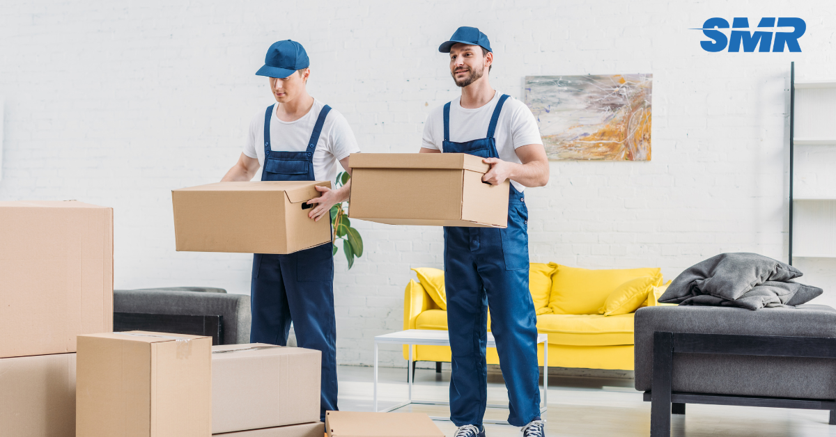 Two movers carrying boxes during a house and flat removal in St John’s Wood