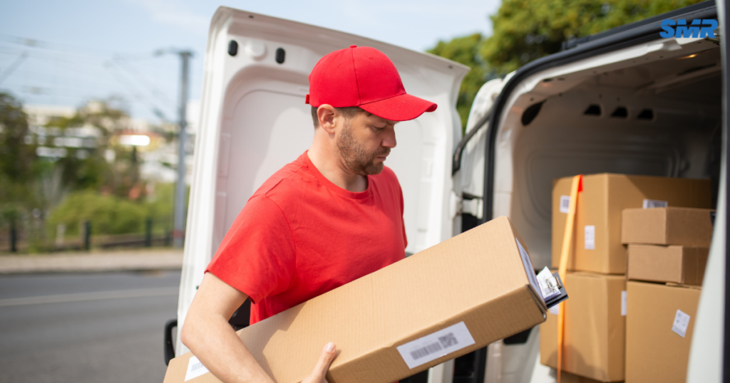 Professional man and van Muswell Hill movers loading furniture into a removal van