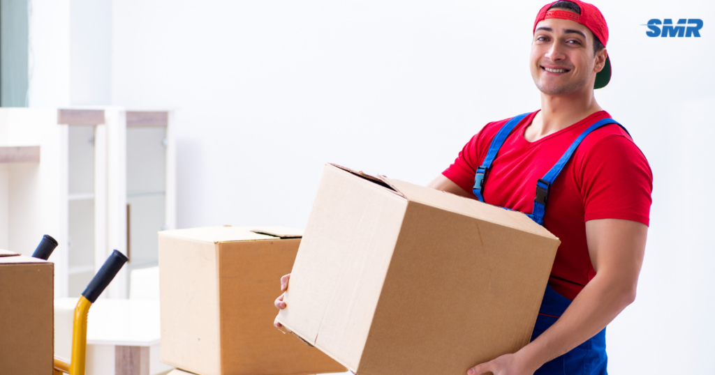 House removals Muswell Hill movers carrying sofa into apartment building
