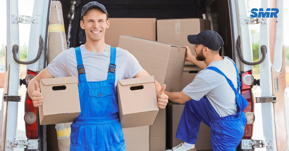 Professional man and van movers unloading boxes in Bexleyheath