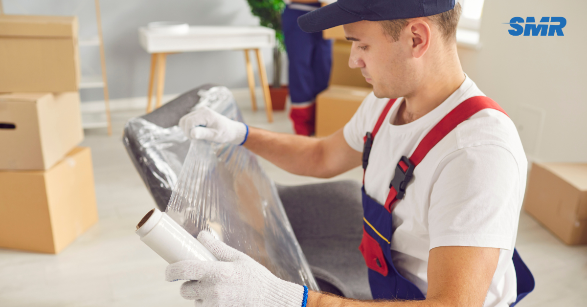 Professional Man and Van RM4 London movers loading furniture and boxes outside a home