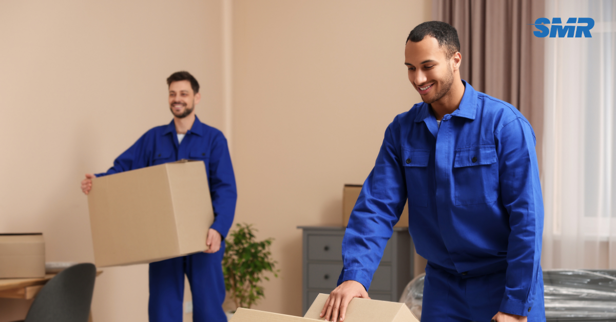 Professional Man and Van RM2 London movers loading furniture and boxes outside a home