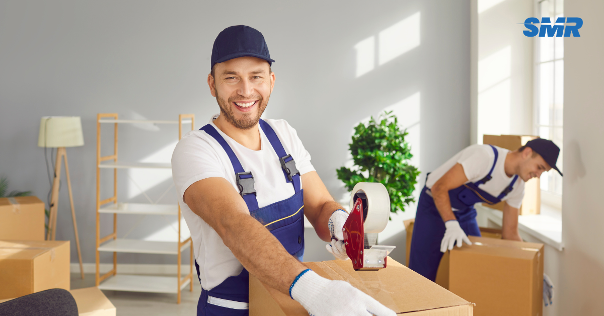 Professional Man and Van RM8 London movers loading boxes outside a home