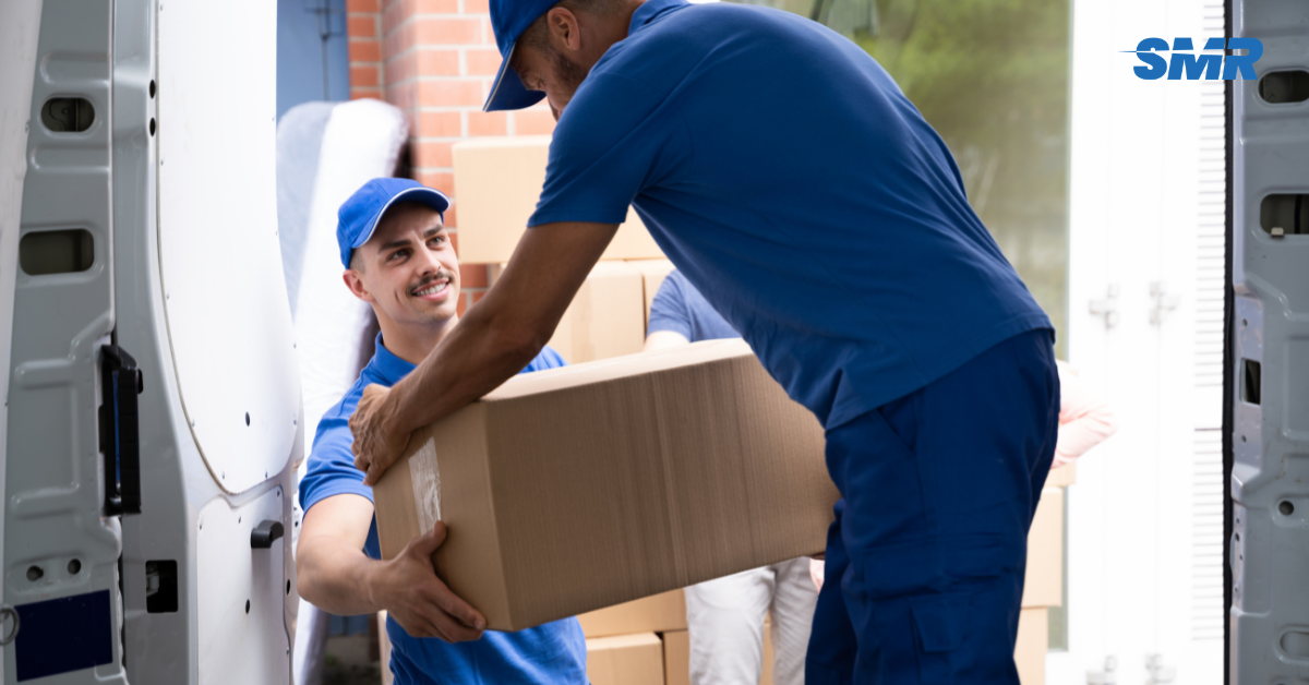Professional Man and Van [Postcode] London movers loading furniture and boxes outside a home