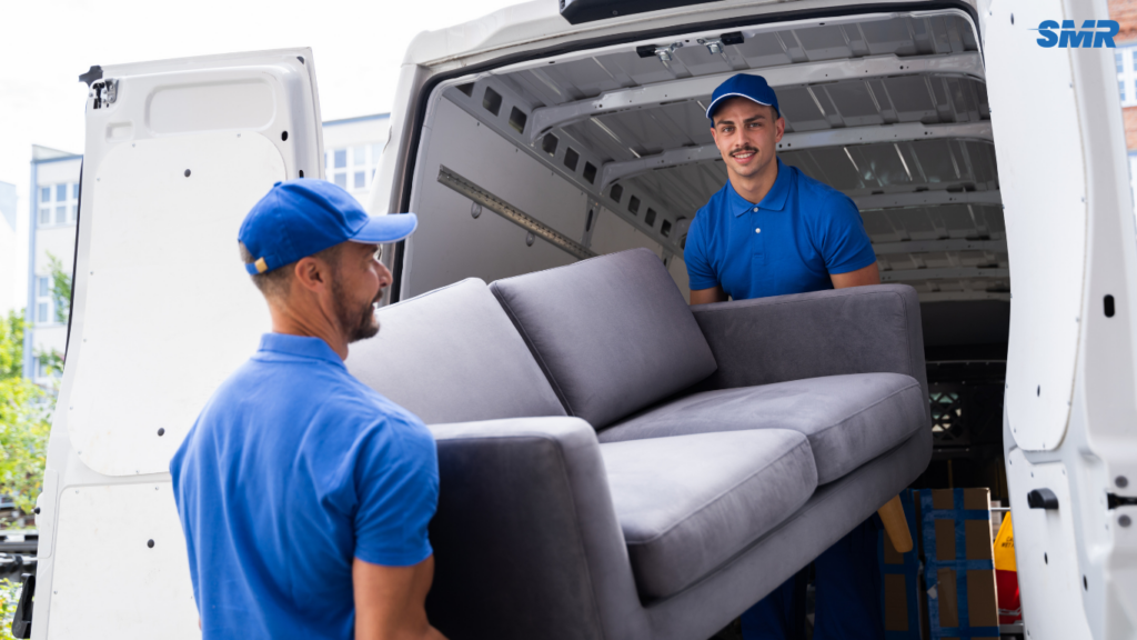 Movers transporting sofa and flat-pack furniture