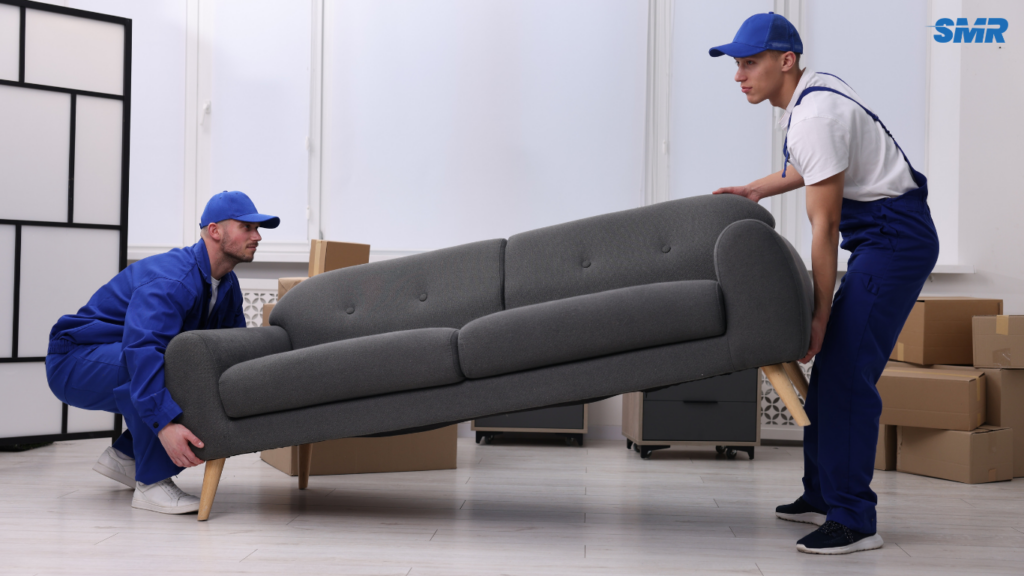 Movers transporting sofa and flat-pack furniture