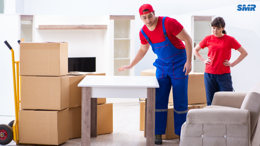 Movers carrying office equipment
