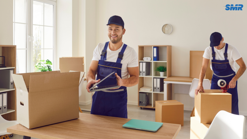 Movers carrying office equipment