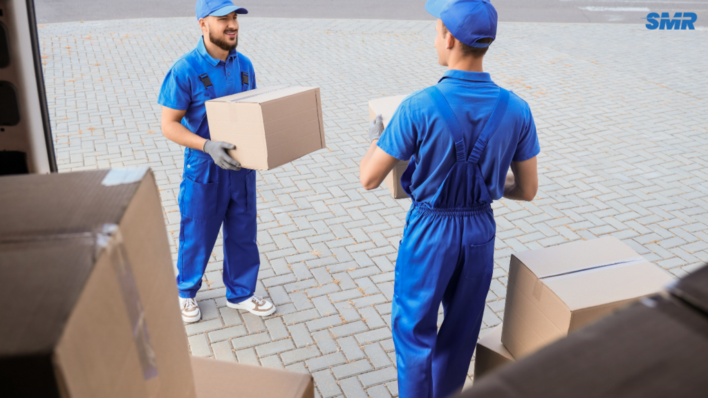 Movers carrying office desks and computers