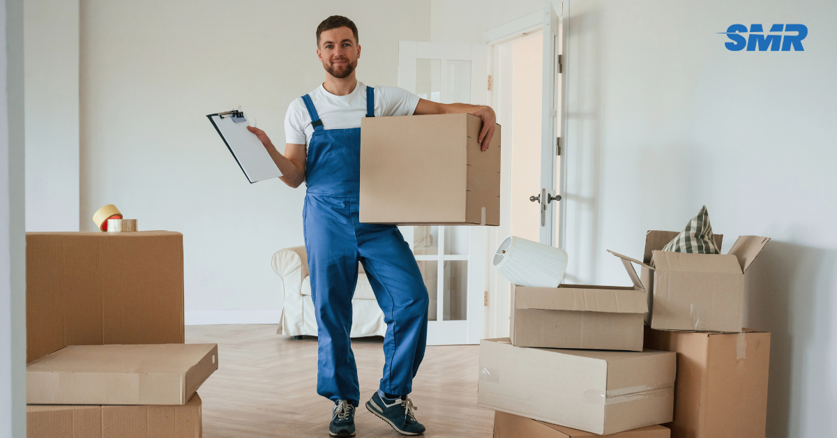 Professional Man and Van SE18 London movers loading boxes and furniture outside a home