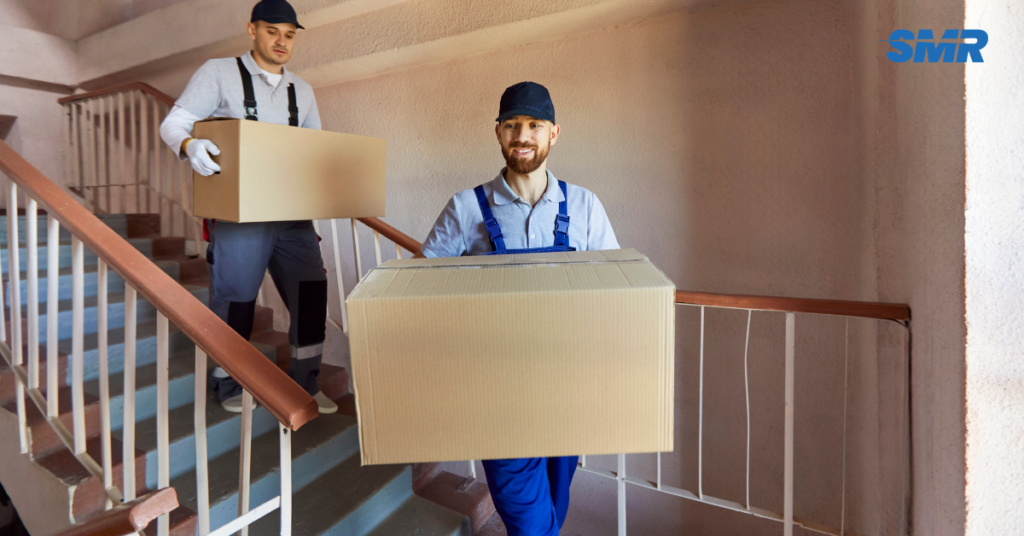 Movers loading office desks and boxes