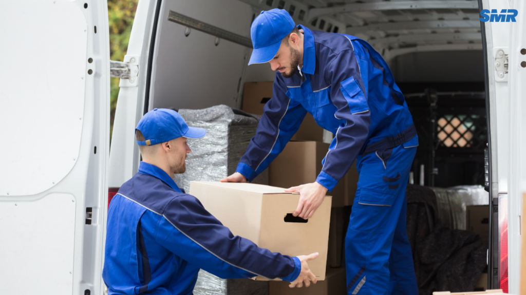 Movers handling sofa and flat-pack furniture